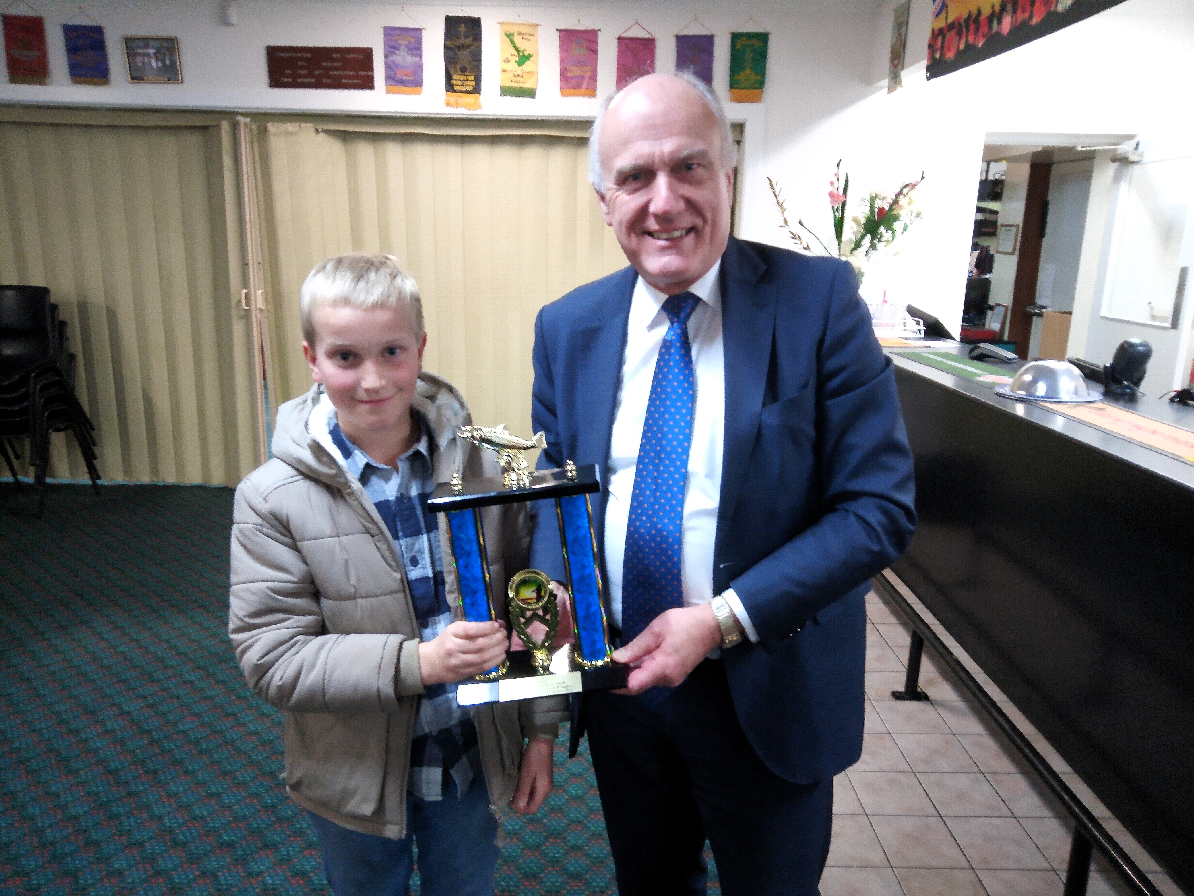 NNLAA Junior Jayden Slater receiving his trophy for winning the Heaviest Trout across all STLAA clubs during the 2023-24 season also presented by Resources MInister Eric Abetz.