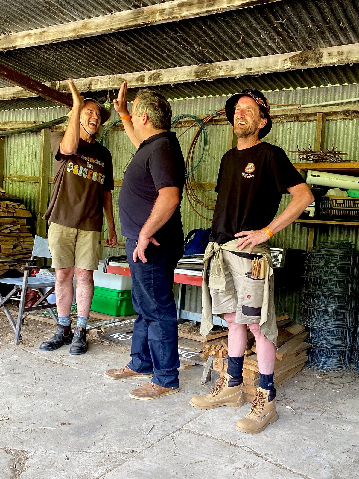 Founder of Grounded Matthew Tack left, high-fiving Shepherd and Author James Redbanks from the UK and Fire landscape manager Jason Andrew Smith. -photo taken by Sarah Coleman