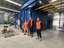 Delmade employees David Knight and Callum Bullock with production manager Hamilton Cunningham near the new powder coating facility