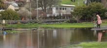  Lachlan plays in the now empty and fully waterlogged New Norfolk Caravan Park with his mum, Olivia.