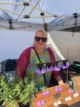 Nina Ahlgren of White Beach makes paper mache garlic shaped earrings.